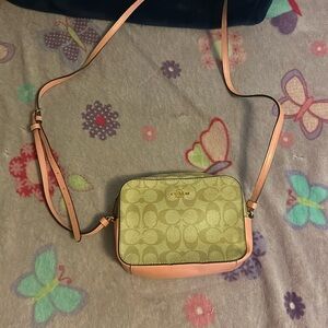 Small coach purse with pocket in the inside and a back pocket as well